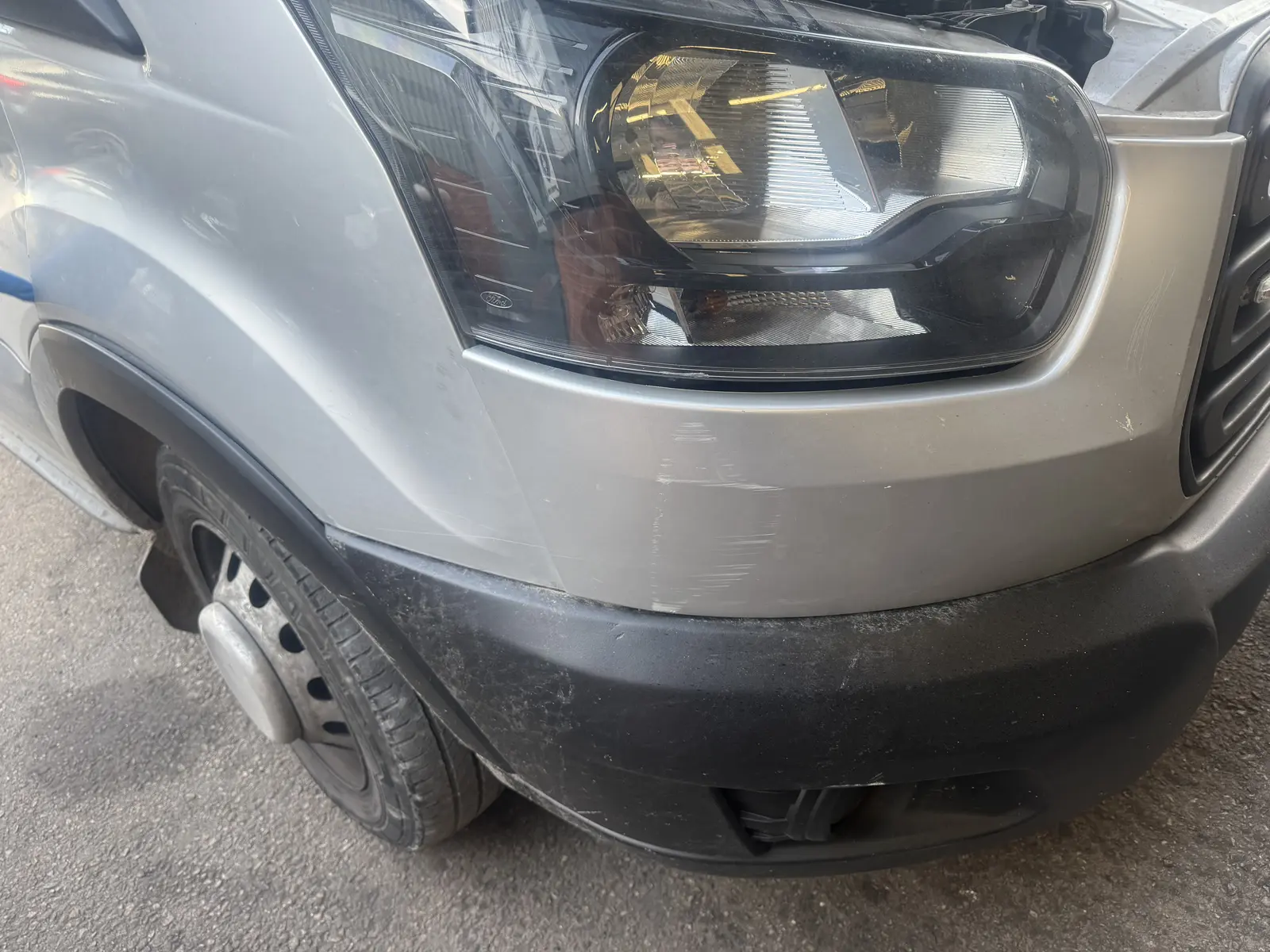 Commercial Ford Transit front-corner damage before repair