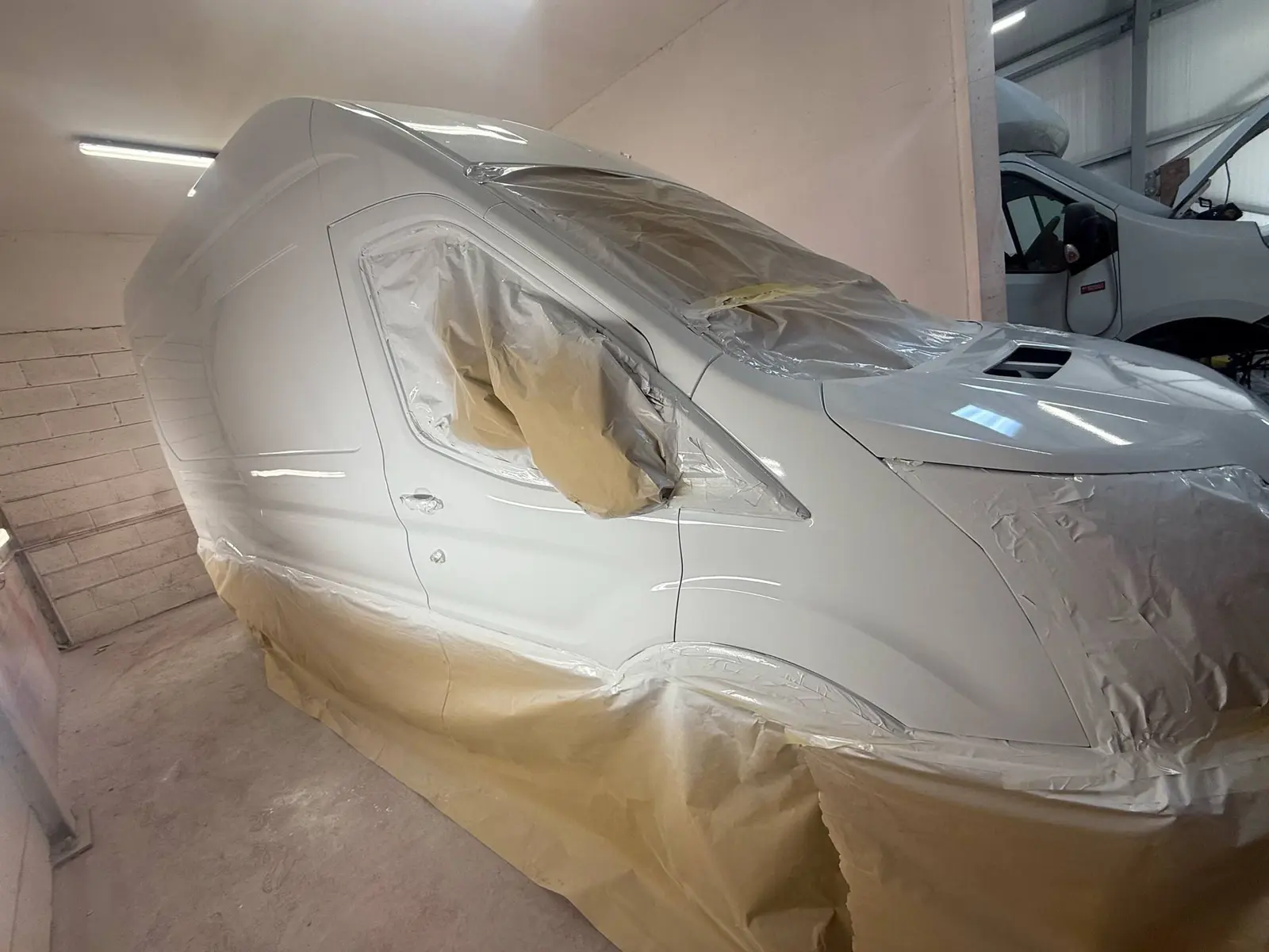 White Ford Transit masked and painted in the bodyshop